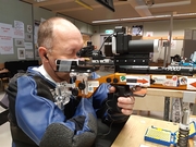 Ein blinder Schütze hochkonzentriert am Gewehr